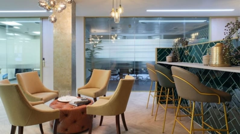 13 Hanover Square's breakout space with beautiful green sofas