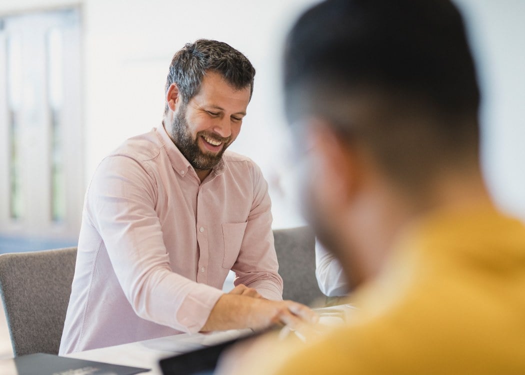 A man laughing in the office
