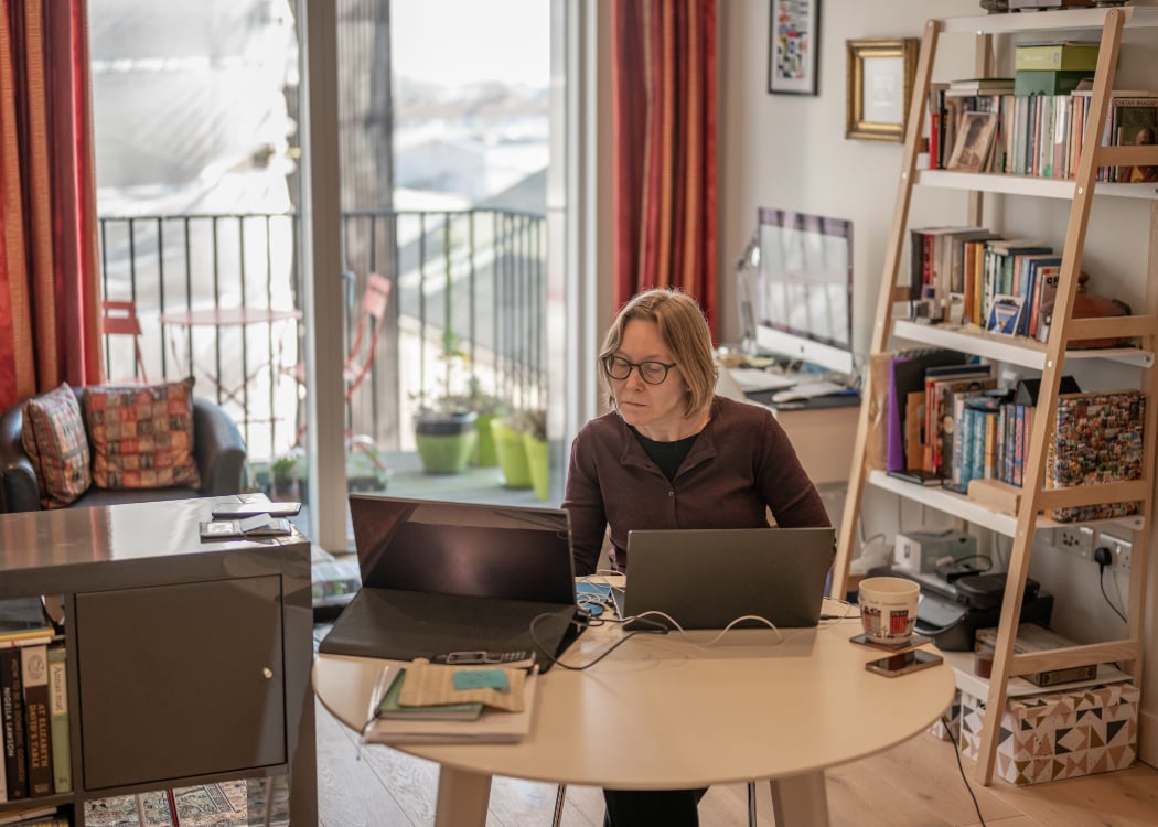 A woman working from home in her living room